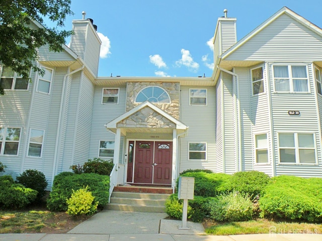 273 Dorset Ct, Piscataway, NJ 08854 - view of front facade featuring a chimney
