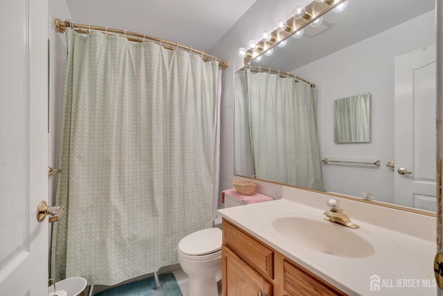 bathroom featuring vanity and toilet