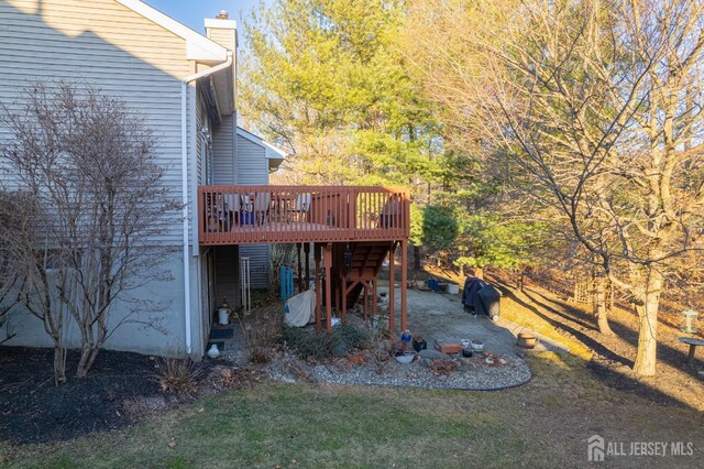 view of yard featuring a patio and a deck