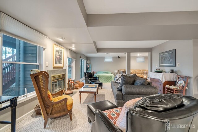 living room with a wealth of natural light and carpet flooring