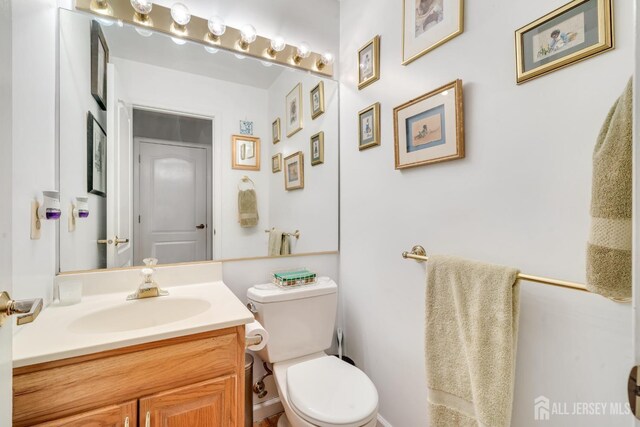 bathroom featuring vanity and toilet