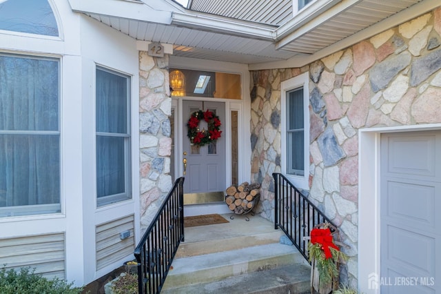 property entrance featuring stone siding