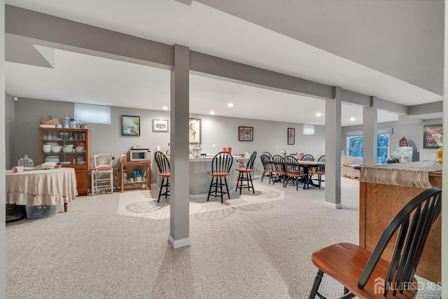 carpeted dining room featuring indoor bar