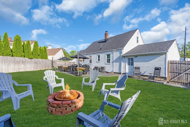 1 Highview Rd, East Brunswick, NJ 08816 - back of property with an outdoor fire pit, a patio area, and a shingled roof