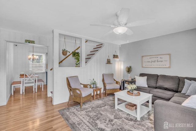 1 Highview Rd, East Brunswick, NJ 08816 - living room with light wood-style flooring, stairs, a ceiling fan, and a chandelier