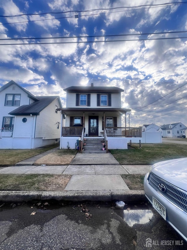 view of front of property featuring covered porch and a front lawn