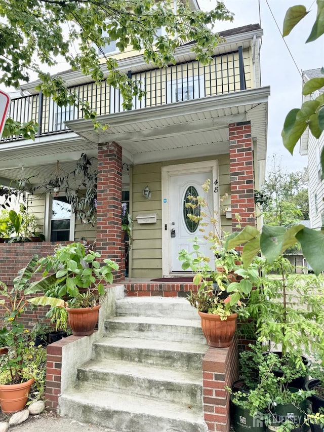 entrance to property with a balcony