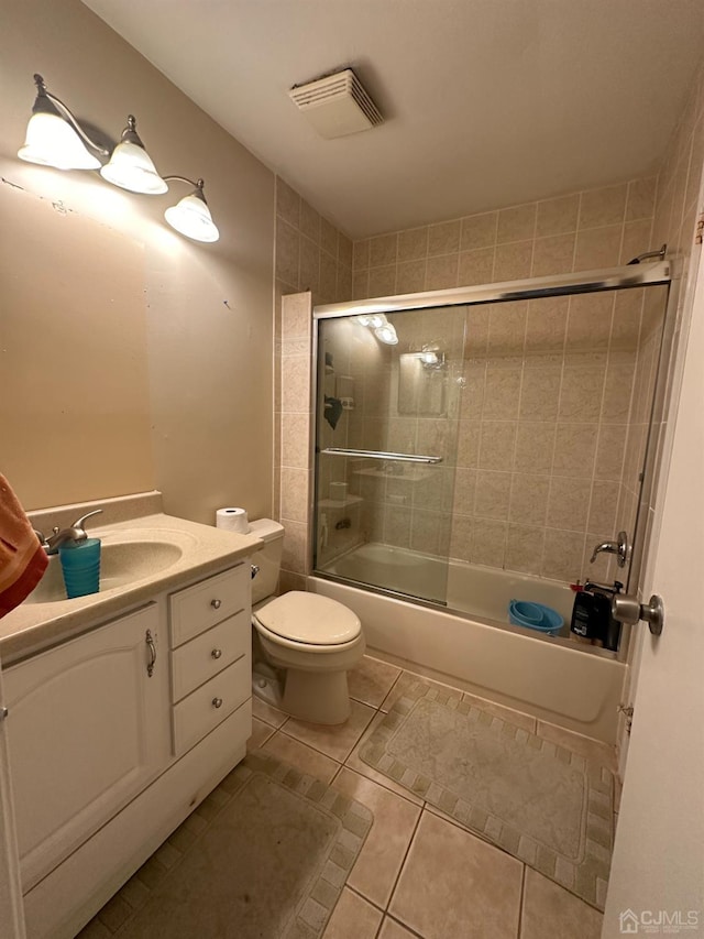 full bathroom featuring vanity, toilet, bath / shower combo with glass door, and tile patterned floors