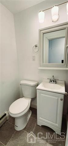 bathroom featuring tile patterned flooring, baseboard heating, vanity, and toilet