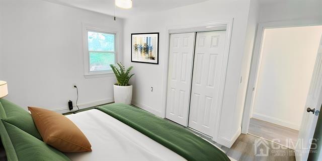 bedroom with a closet and light wood-type flooring