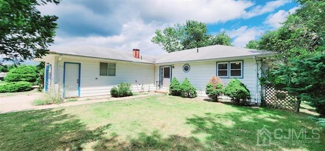 back of house with a lawn