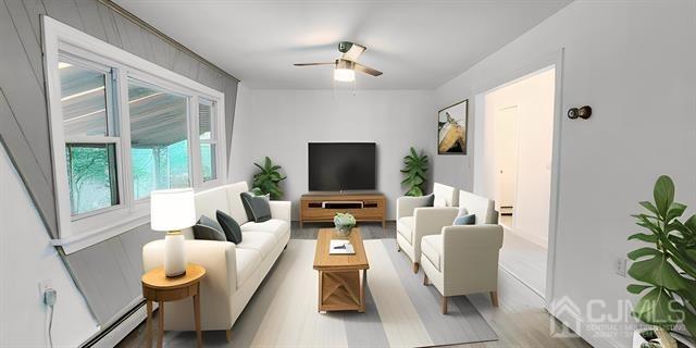 living room with light hardwood / wood-style flooring, ceiling fan, and baseboard heating