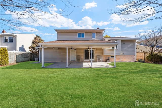 rear view of property with a patio, a yard, fence, and ceiling fan