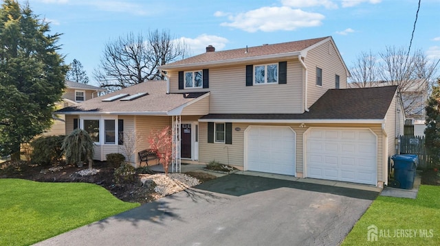 view of front of home with aphalt driveway, a chimney, a garage, and roof with shingles