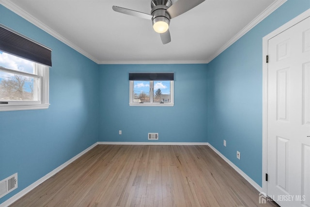 unfurnished bedroom with visible vents, baseboards, and wood finished floors