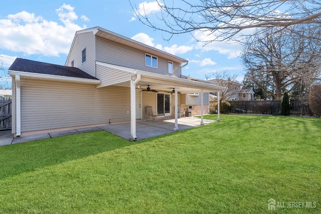 rear view of house with a yard, a patio area, a ceiling fan, and fence