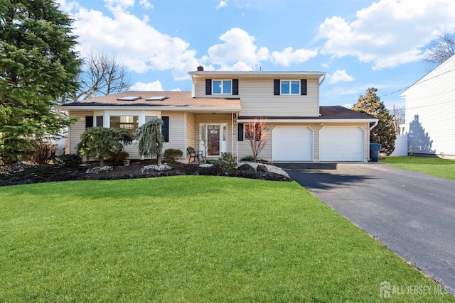 traditional-style home with aphalt driveway, a front yard, a chimney, and a garage