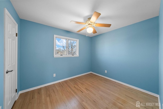 unfurnished bedroom featuring wood finished floors, baseboards, and ceiling fan