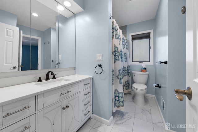 bathroom with vanity, toilet, baseboards, and marble finish floor