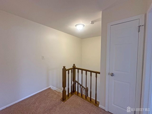 stairway featuring carpet floors and baseboards
