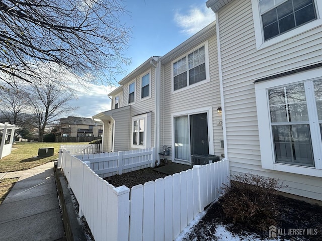 view of property exterior with a fenced front yard