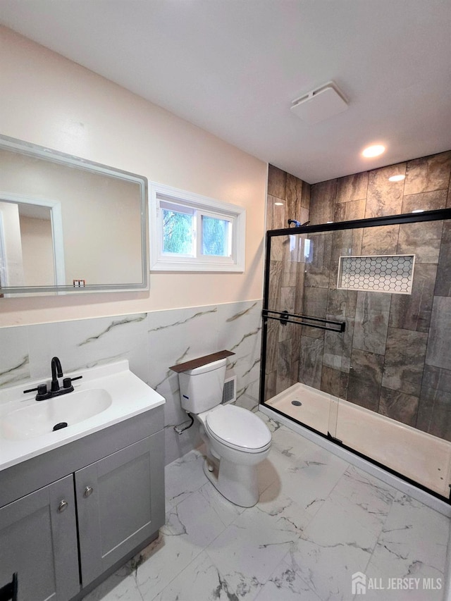 81 Hickory St, Carteret, NJ 07008 - full bath featuring marble look tile flooring, vanity, a stall shower, tile walls, and wainscoting