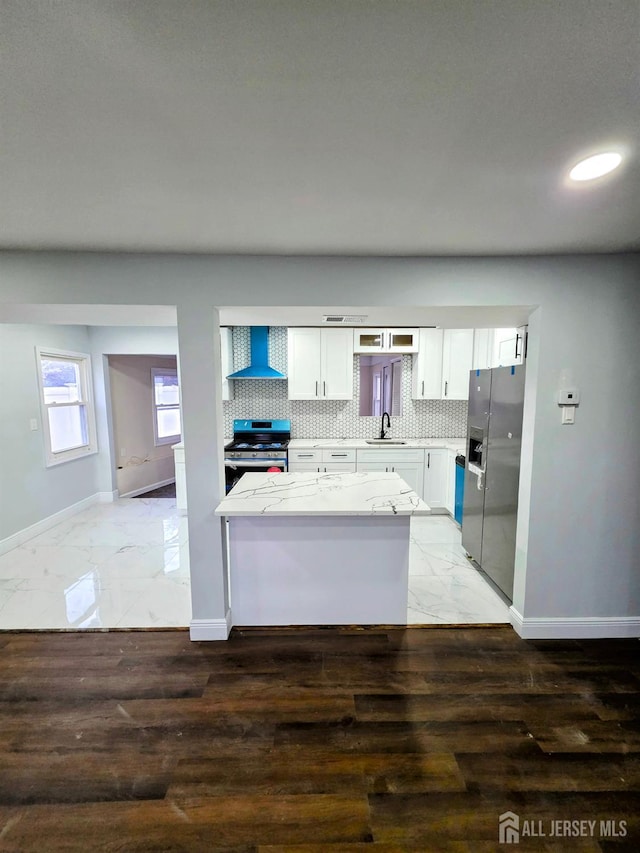 81 Hickory St, Carteret, NJ 07008 - kitchen with appliances with stainless steel finishes, wall chimney exhaust hood, white cabinets, light marble finish flooring, and recessed lighting