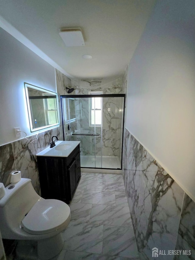 81 Hickory St, Carteret, NJ 07008 - bathroom featuring tile walls, vanity, marble finish floors, a marble finish shower, and wainscoting