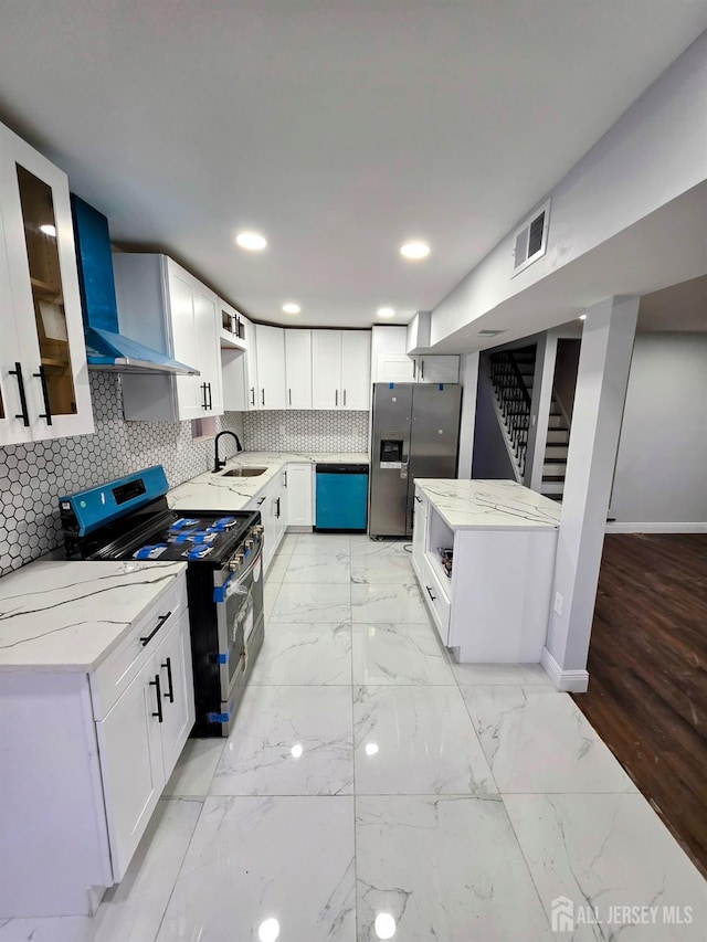 81 Hickory St, Carteret, NJ 07008 - kitchen with appliances with stainless steel finishes, light stone countertops, tasteful backsplash, wall chimney exhaust hood, and white cabinets