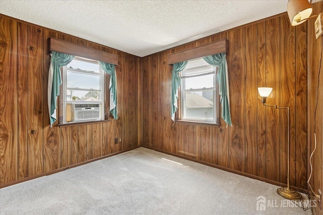 78 Bernard St, Carteret, NJ 07008 - spare room featuring a textured ceiling, wooden walls, and carpet