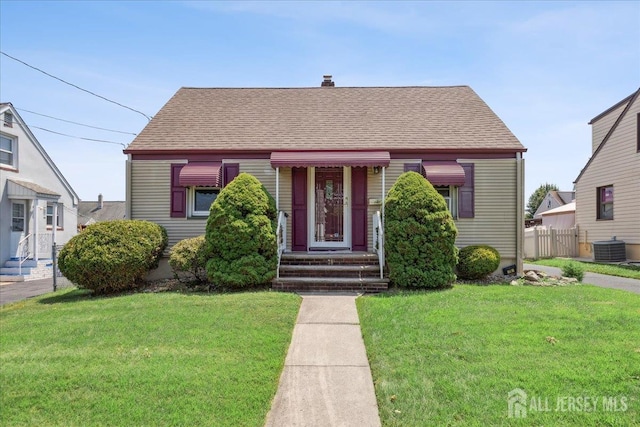 78 Bernard St, Carteret, NJ 07008 - view of front of property with a shingled roof, a chimney, and entry steps