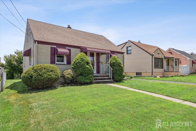 78 Bernard St, Carteret, NJ 07008 - view of front of property with a shingled roof, a front lawn, and a chimney