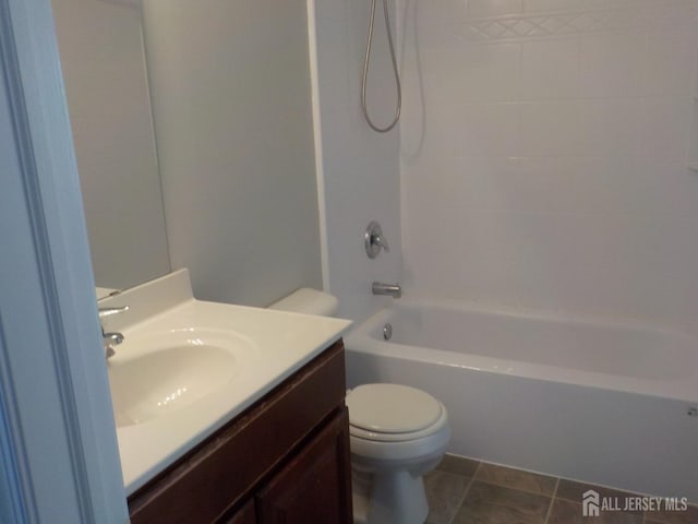bathroom featuring toilet, vanity, and shower / bathtub combination