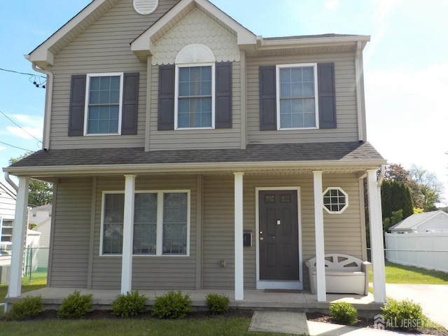 view of front facade with covered porch and fence