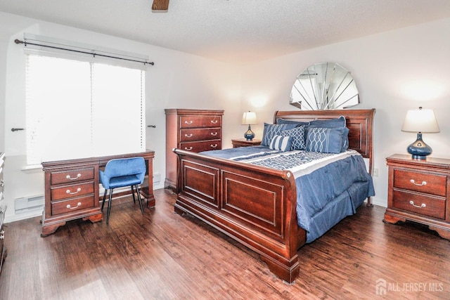 bedroom featuring a textured ceiling and wood finished floors