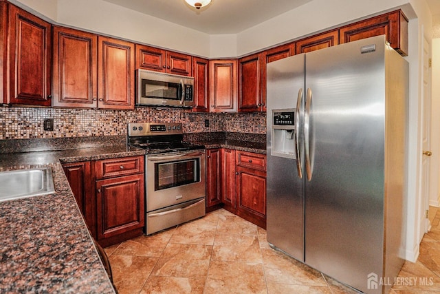 kitchen with stainless steel appliances, tasteful backsplash, and a sink