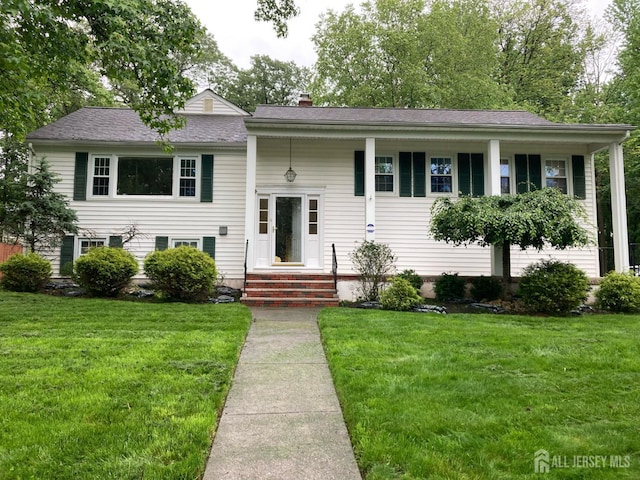 9 NW Fielding Pl, Edison, NJ 08820 - raised ranch featuring a front lawn and a chimney
