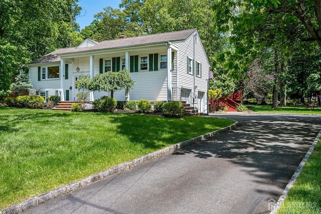 9 NW Fielding Pl, Edison, NJ 08820 - raised ranch featuring asphalt driveway, a chimney, a front yard, and a shingled roof