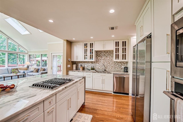 9 NW Fielding Pl, Edison, NJ 08820 - kitchen featuring appliances with stainless steel finishes, healthy amount of natural light, a skylight, open floor plan, and recessed lighting