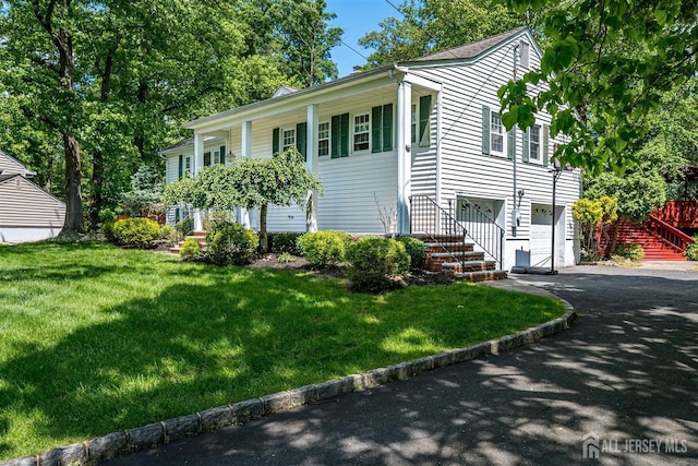 9 NW Fielding Pl, Edison, NJ 08820 - view of front of property featuring driveway, stairs, a garage, and a front lawn