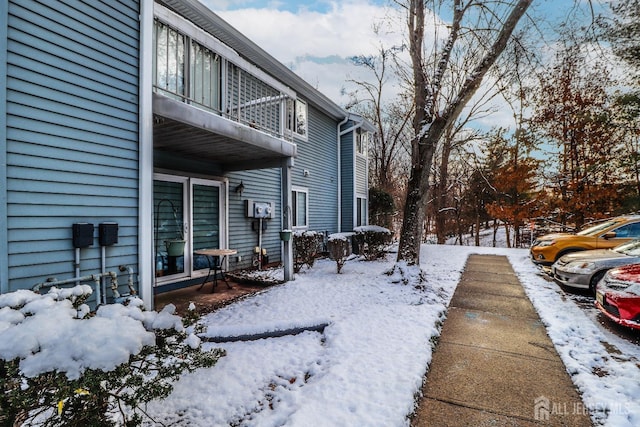 view of snow covered exterior featuring a balcony