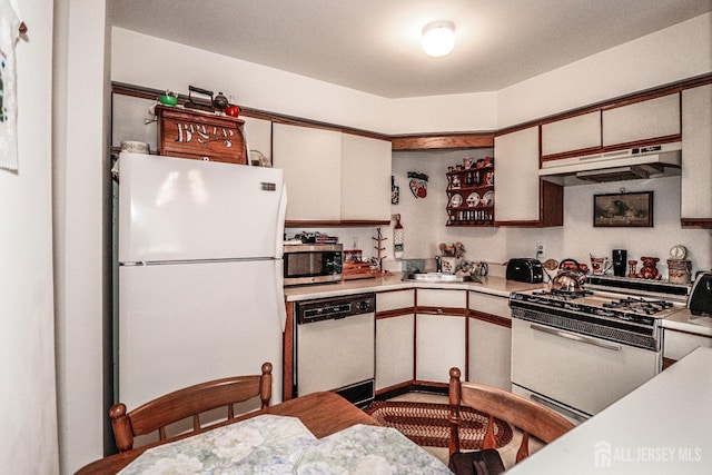 kitchen featuring white cabinetry, white appliances, and sink