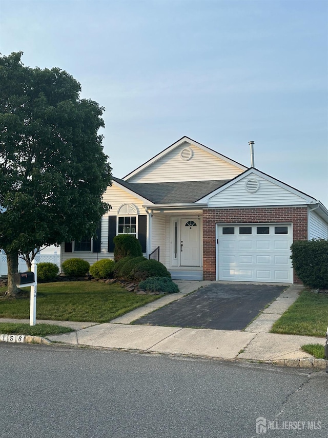 156 Prince Charles Dr, Toms River, NJ 08757 - view of front of home with a garage, asphalt driveway, a front yard, and brick siding
