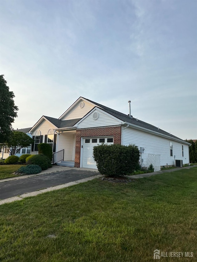 156 Prince Charles Dr, Toms River, NJ 08757 - ranch-style home featuring a garage, a front yard, driveway, and brick siding