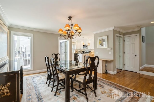 580 Patten Ave Unit 53, Long Branch, NJ 07740 - dining space featuring a chandelier, light wood-style flooring, baseboards, and ornamental molding