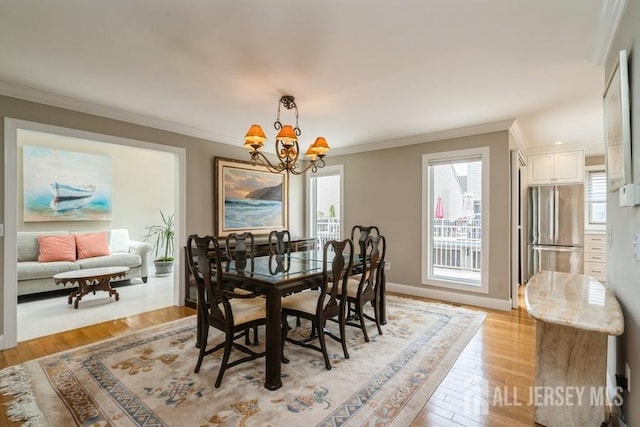 580 Patten Ave Unit 53, Long Branch, NJ 07740 - dining room featuring a chandelier, crown molding, light wood-style flooring, and baseboards