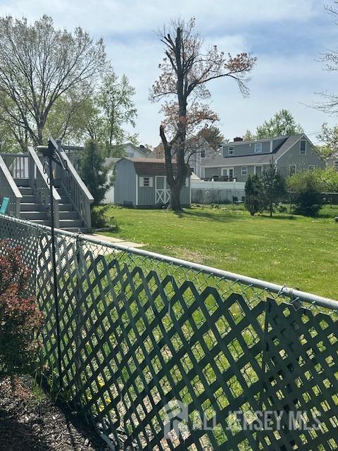 68 Suydam Ave, Edison, NJ 08817 - fenced yard featuring a storage unit and stairs