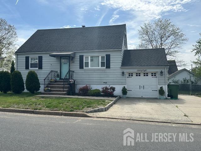 68 Suydam Ave, Edison, NJ 08817 - cape cod house with an attached garage, concrete driveway, and roof with shingles