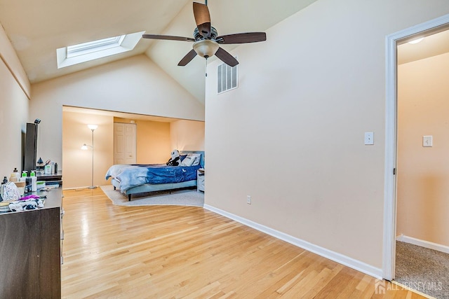 bedroom featuring light wood-type flooring, visible vents, baseboards, and a skylight