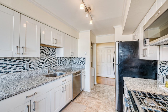 kitchen with a sink, tasteful backsplash, stainless steel appliances, white cabinets, and crown molding